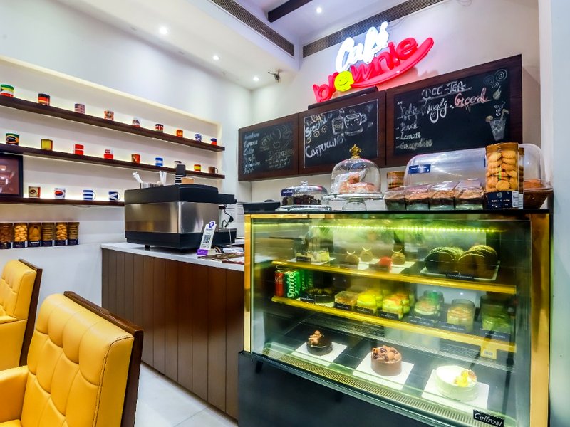 Café Brownie pastry counter and espresso station at Hotel Grand Godwin