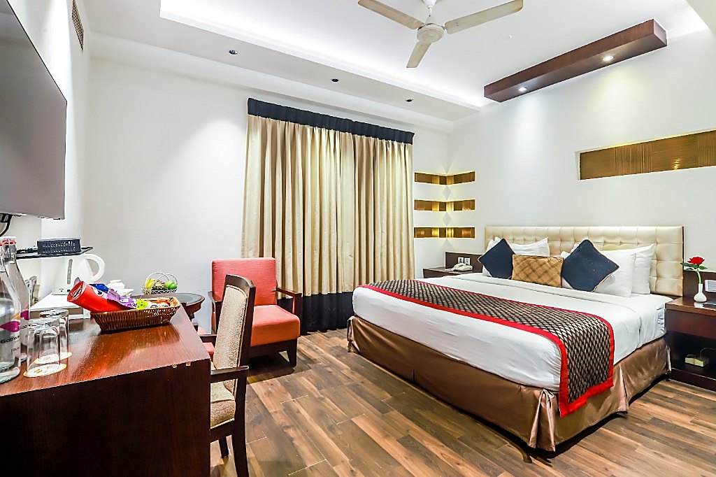 Premier Studio King Room with Air-Purifier at Hotel Godwin Deluxe — 450 sq.ft suite with king bed, executive desk, and lounge seating